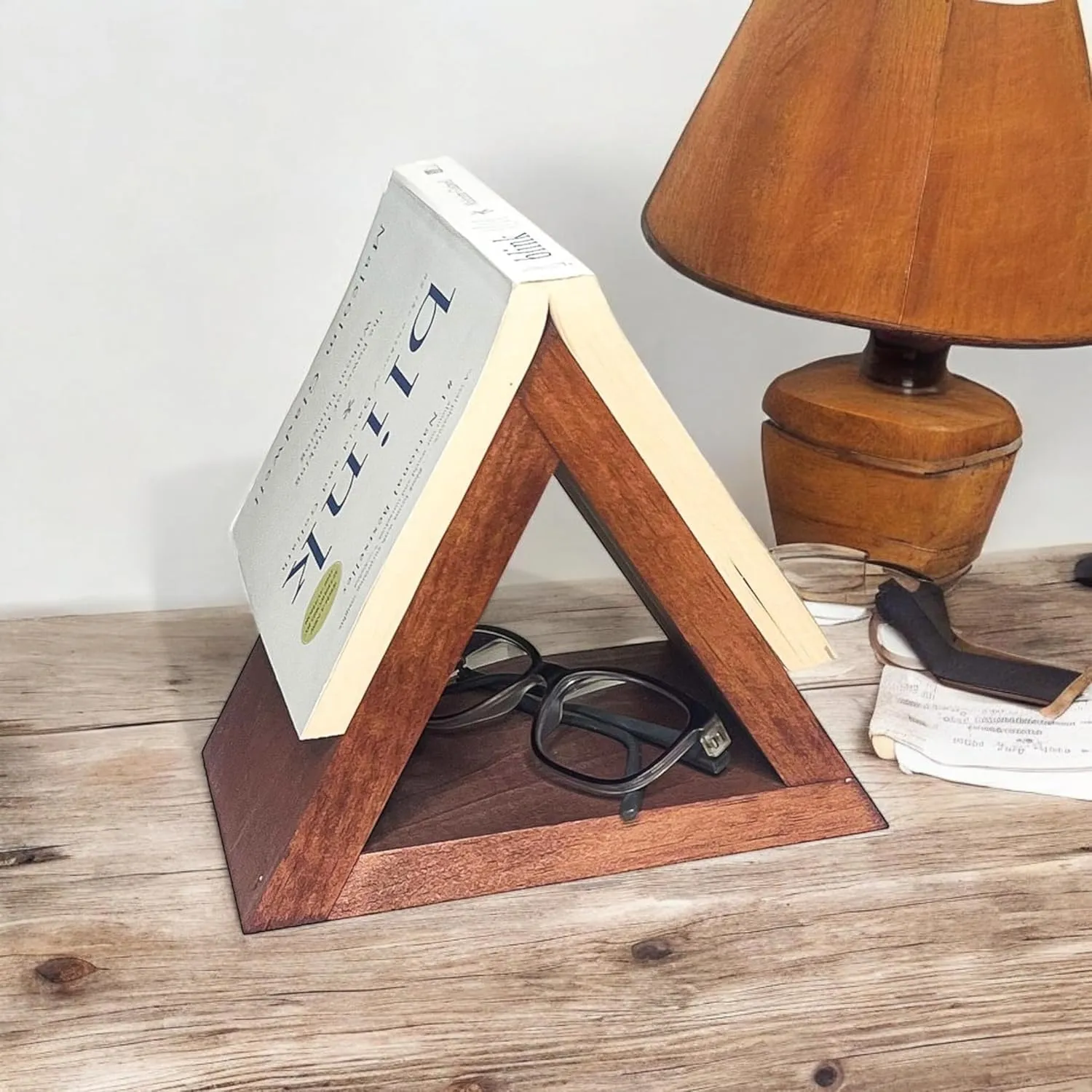 The wooden tone book stand with eyeglass holder for bedside organization use made with wood offers multifunctional storage solution