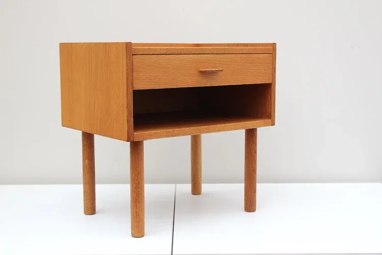 The wooden tone bedside table with drawers for storage use made from wood with sturdy design