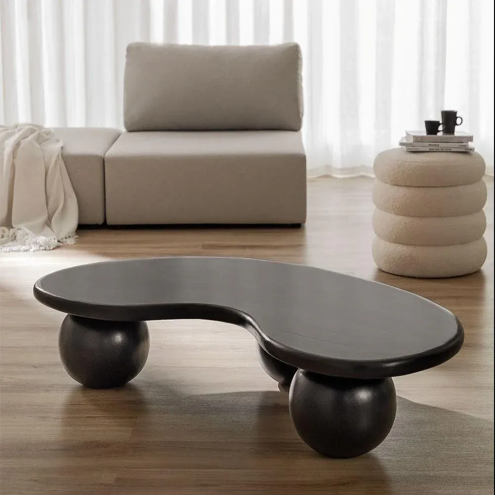 The wooden tone center table for living room use crafted from mango wood in black finish