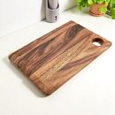 Natural mango wood chopping board with smooth finish and rustic grain pattern, perfect for cutting and serving in the kitchen.